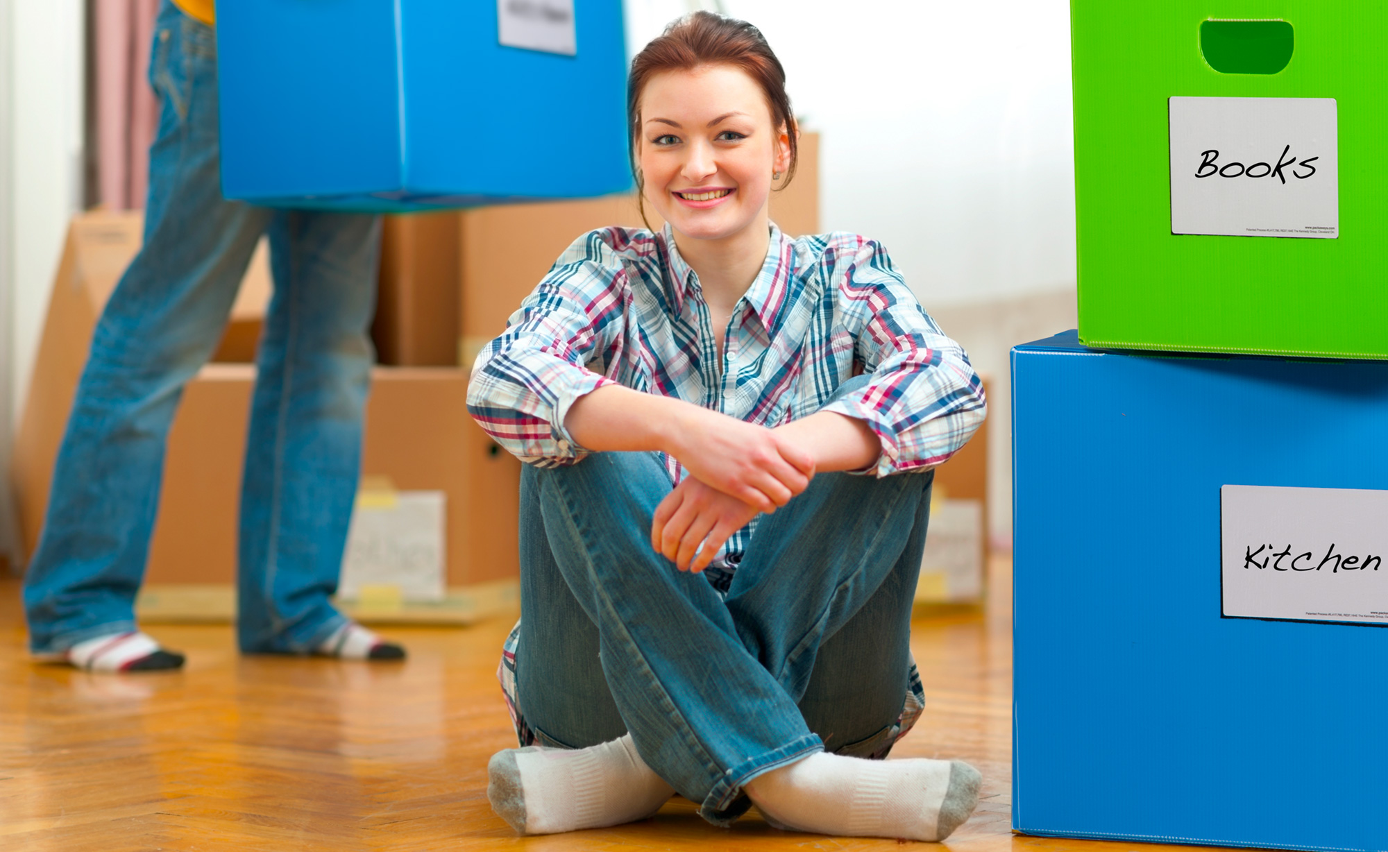 Woman Smiling Sitting Next to PackAways Boxes